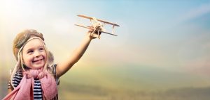 Freedom To Dream - Joyful Child Playing With Airplane Against The Sky